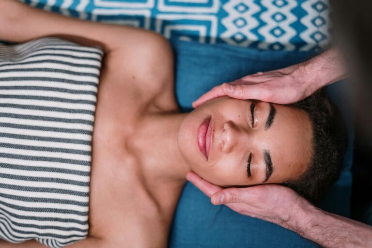Woman receiving facial massage.
